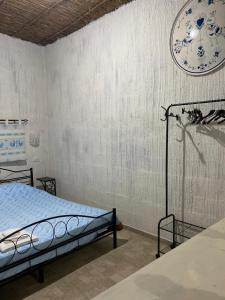 a bedroom with a bed and a clock on the wall at Casa Pili in San Vito