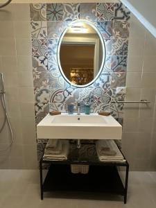 a bathroom with a sink and a mirror at Romantico bilocale ad Ortigia in Syracuse +10 photos