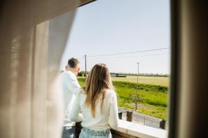 a man and a woman looking out of a window at Ca' Foega rooms in Chioggia