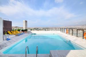 a swimming pool on the roof of a building at Dorian Inn - Sure Hotel Collection by Best Western in Athens
