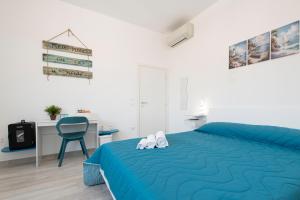 a bedroom with a blue bed and a blue chair at L'Ulivo bed and breakfast in Decima