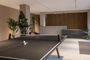a ping pong table in a living room at The Pepper Mill - Campus Residence in Edinburgh