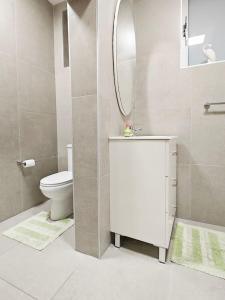 a bathroom with a toilet and a sink and a mirror at Dar Marija in Valletta +28 photos