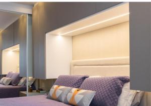 a bedroom with a bed and a large mirror at Metropolitan Sidney in Goiânia +19 photos