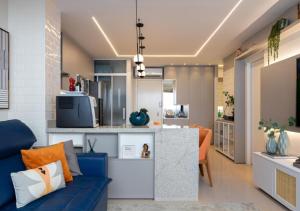 a living room with a blue couch and a kitchen at Metropolitan Sidney in Goiânia