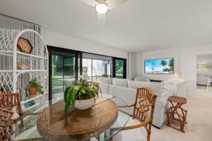 a living room with a couch and a table and chairs at Mariner Pointe #521 in Sanibel