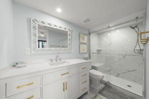 a white bathroom with a sink and a shower at Mariner Pointe #521 in Sanibel +34 photos