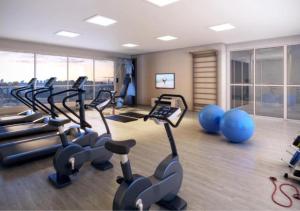a gym with treadmills and exercise bikes in a room at Metropolitan Sidney in Goiânia