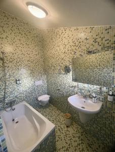 a bathroom with a tub and a sink and a toilet at Corrubedo Beach Lodge in Corrubedo