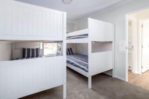 a bedroom with two bunk beds and a bed at Arthurs Vineyard - Sleeps 10 in Martinborough +14 photos
