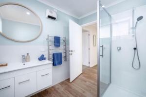 a bathroom with a shower and a mirror at Arthurs Vineyard - Sleeps 10 in Martinborough