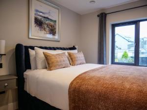 a bedroom with a large bed and a window at Dingle Doorstep - Town Centre in Dingle