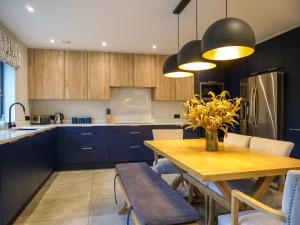 a kitchen with a wooden table and a dining room at Dingle Doorstep - Town Centre in Dingle