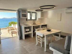 a kitchen and dining room with a view of the ocean at Daphne in Naousa