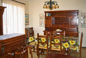a dining room with a table and chairs with flowers on them at Casa Mariarosa in Maccagno Inferiore