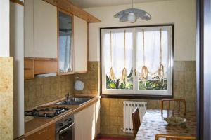 a kitchen with a sink and a window at Casa Mariarosa in Maccagno Inferiore