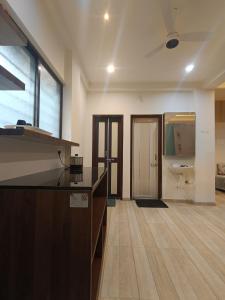 a bathroom with a sink and a toilet in a room at Desai Home Stay in Kolhapur