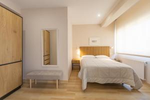 a bedroom with a large bed and a mirror at Hotel Ros Mary in Ribadeo