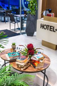 a pile of books on a coffee table at Duka's Boutique Hotel in Ksamil