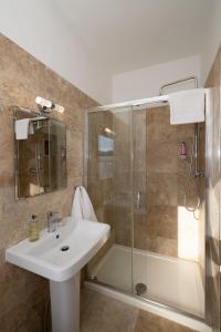 a bathroom with a sink and a shower at Abbey View Townhouse in Youghal +67 photos