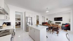 a kitchen and living room with a table and a dining room at Modern-Detached 5 Bedroom100 Spotless-Sleeps 13 in Caledon East