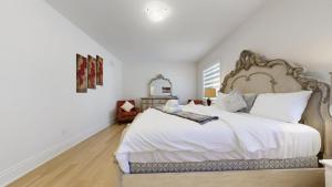 a bedroom with a large bed with white sheets at Modern-Detached 5 Bedroom100 Spotless-Sleeps 13 in Caledon East