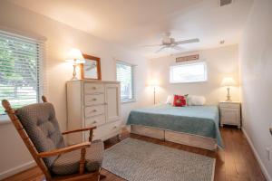 a bedroom with a bed and a dresser and a chair at Lake Views & Fire Pit in South Haven