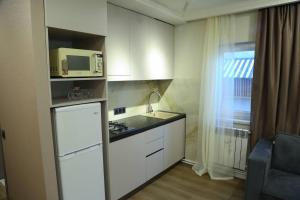 a small kitchen with a sink and a microwave at Bellissimo Garden Villa in Tsaghkadzor