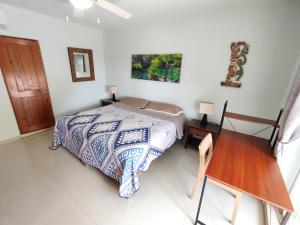 a bedroom with a bed and a wooden table at Beautiful apartment, prime location, beach 2 minutes away in Puerto Aventuras