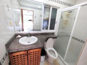 a bathroom with a sink and a toilet and a shower at Beautiful apartment, prime location, beach 2 minutes away in Puerto Aventuras +14 photos