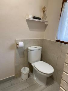 a bathroom with a toilet and a roll of toilet paper at La Casuca ONE De Lebeña in Lebena