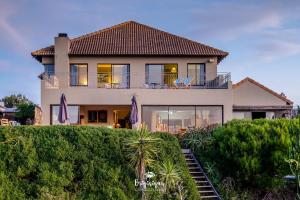 a house on top of a hill with bushes at Boardwalk in Britannia Bay