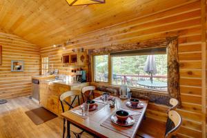 a kitchen with a table and chairs in a cabin at 3-Cabin Base w/ Lake Access: Dogs Welcome! in Soldotna