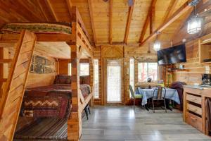 a bedroom in a log cabin with a bed and a table at 3-Cabin Base w/ Lake Access: Dogs Welcome! in Soldotna