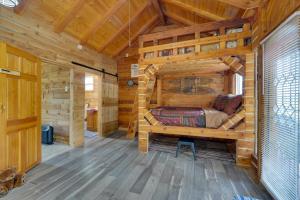 a bedroom with a bed in a wooden cabin at 3-Cabin Base w/ Lake Access: Dogs Welcome! in Soldotna