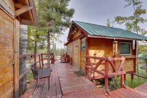 a cabin with a wooden deck in the woods at 3-Cabin Base w/ Lake Access: Dogs Welcome! in Soldotna