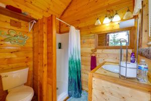 a log cabin bathroom with a toilet and a sink at 3-Cabin Base w/ Lake Access: Dogs Welcome! in Soldotna +37 photos