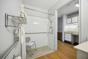 a bathroom with a shower and a sink at HomeTowne Studios by Red Roof Atlanta - Peachtree Corners in Norcross +26 photos