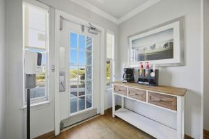 a room with a table with a microwave and a window at HomeTowne Studios by Red Roof Atlanta - Peachtree Corners in Norcross