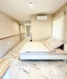 a bedroom with a bed and a tiled floor at Троїцька площа 3 Квартира Самий Центр Окремий Вхід in Dnipro