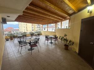 a room with tables and chairs in a building at Hotel Yjet in Pogradec