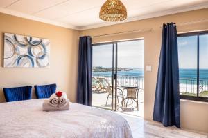 a bedroom with a bed with a view of the ocean at Boardwalk in Britannia Bay +18 photos