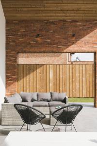 a living room with a couch and two chairs at Vakantiewoning 't Veld in Ledegem