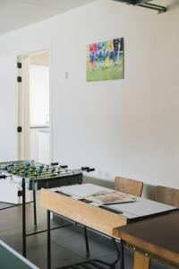 a room with two ping pong tables and chairs at Vakantiewoning 't Veld in Ledegem