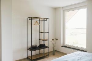 a black book shelf in a bedroom with a window at Vakantiewoning 't Veld in Ledegem +43 photos