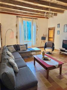 a living room with a couch and a coffee table at "La Maison de Villars" au coeur de la nature in Pressac