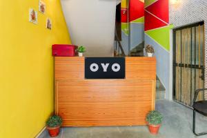 a wooden door with the ovo sign on it at Hotel O Green Park Residency 2 in New Delhi
