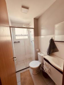 a bathroom with a shower and a toilet and a sink at Apt 404 BL 6 entrada de londrina in Cambé