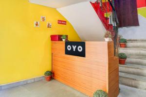 a wooden door with the word oxo on it next to stairs at Hotel O Green Park Residency 2 in New Delhi