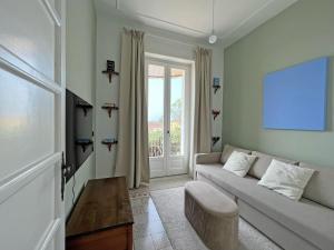 a living room with a couch and a window at Villa Ipomea - Cielo Suite in Salerno +10 photos